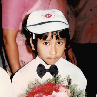 Boy holding a bouquet at a ceremony