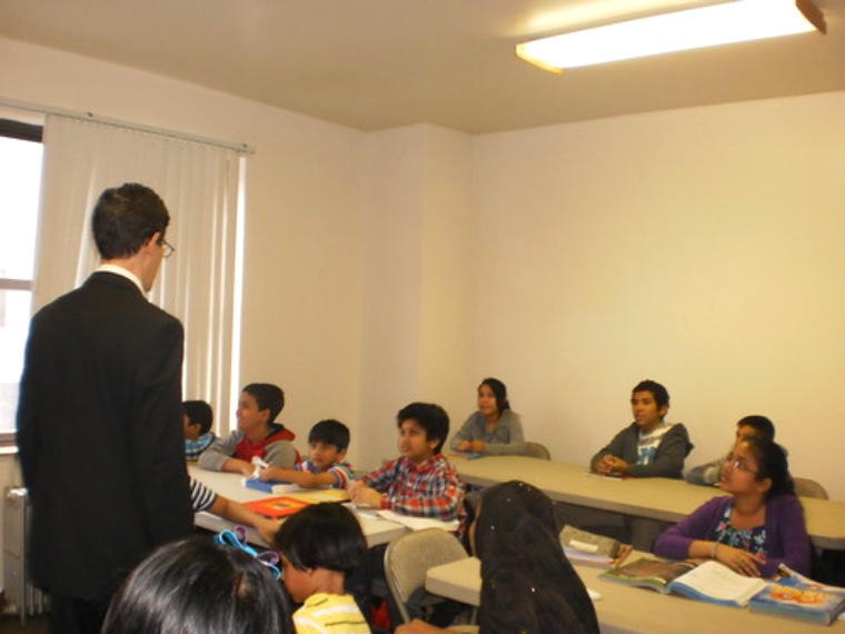 A mentor teaching students in a classroom